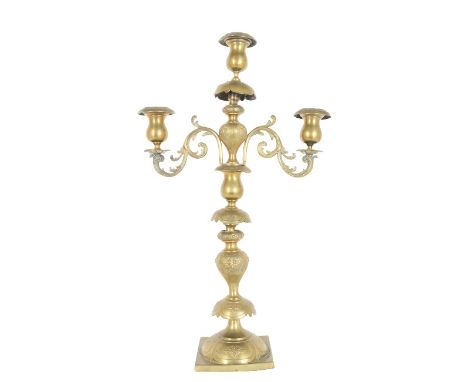 Three candle brass candelabra, comes apart in the middle to be converted to a single candlestick. 22 3/4 in. tall