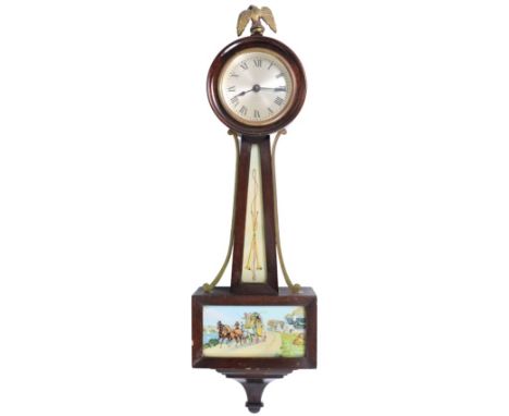 Seth Thomas banjo clock with image of a horse-drawn carriage, eagle finial. Unknown as to working order. Size: 6 x 2 1/2 x 21