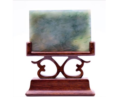 20th C Chinese Jade plaque, rectangular jade plaque with variations through out, held by a carved wood stand. Size: 3 1/4 x 1