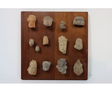 Variety of stone-like &amp; ceramic imagery, mainly faces. Overall size: 11 x 11 in.