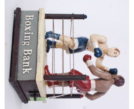 BOXING MONEY BOX: A 20th century vintage style cast iron money box in the form of a boxing ring, with 2x painted figures. The