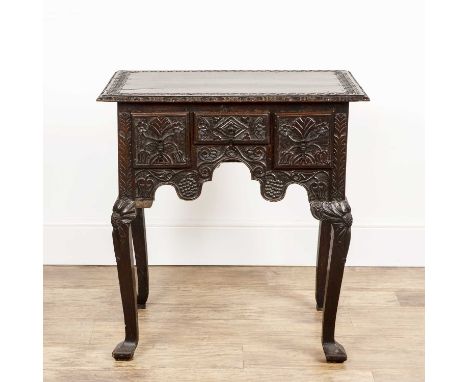 Oak side table 18th Century, with carved decoration throughout, fitted with three frieze drawers having iron handles, standin