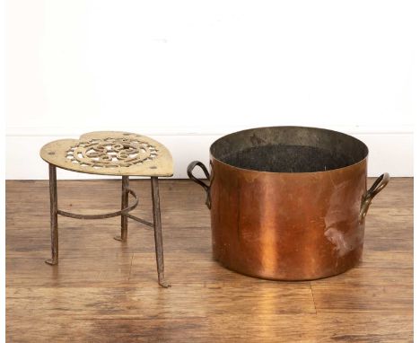 Large copper saucepan or cooking pot with twin brass handles, unmarked, 29.5cm high overall, and a large trivet with pierced 