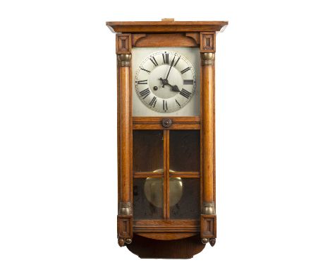 Oak cased Vienna style wall clock 19th Century, with lattice effect door, enclosing a silvered dial with Roman numerals, 33cm