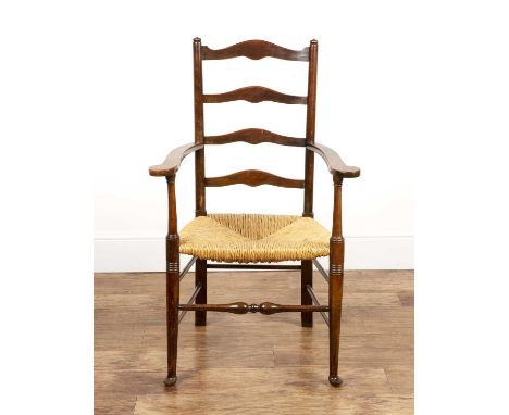 Arts and Crafts style stained beech ladderback armchairwith a rush seat, 64cm wide x 103.5cm highProvenance: The Olivia Dell 