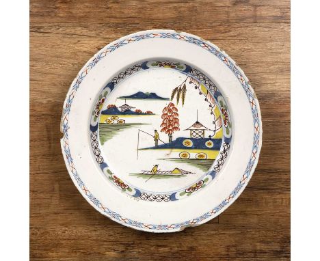 Polychrome Delftware chargerEnglish, circa 1780, painted with a Chinese landscape and fishermen, 34cm diameter  With signs of