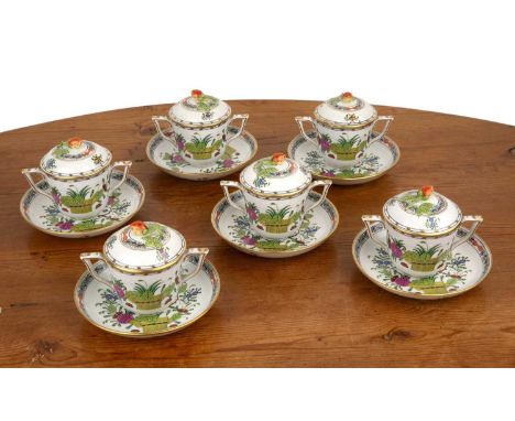 Herend Hungary setto include six lidded pots, with strawberry finials to the lid, 10cm high and six saucers, 14.5cm diameter,