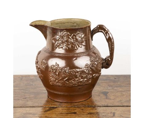 Large glazed hunting jug19th Century, with a greyhound handle, 24cm high  Chip on the rim and further chips and cracks to the