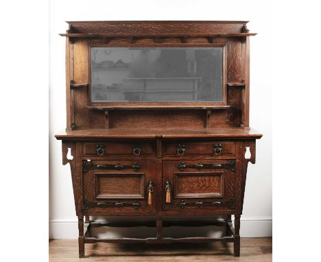 Attributed to Shapland & Petter Arts and Crafts oak sideboard with metal mounts, the mirrored back with open shelves, 152cm w