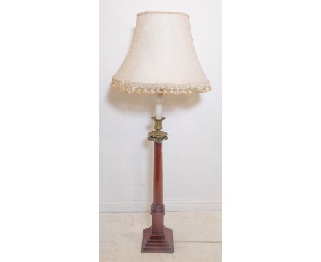 A brass-mounted turned mahogany lamp standard with shade; the patinated brass modelled as a Doric column above a square stepp
