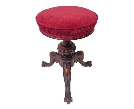 A good mid 19th century circular topped adjustable rosewood music/piano stool; bulbous gadrooned stem and three moulded downs