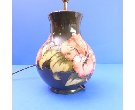 A Moorcroft table lamp of Hibiscus pattern (24cm high x 18cm wide)