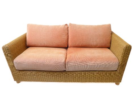 A large conservatory-style wickerwork sofa with cushions (175cm wide x 87cm deep)