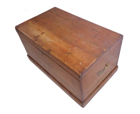 A 19th century polished pine trunk of good colour; the hinged lid opening to reveal candle box with two large brass carrying 