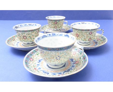 A set of four Chinese porcelain cups and saucers; hand-decorated in enamels, the cups with interior border of bats and each c