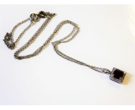 A white-gold, ruby and diamond cluster pendant and chain