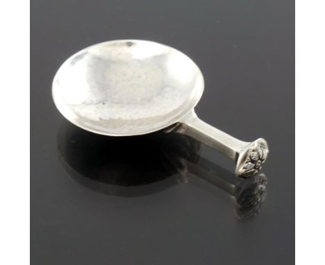 A E Jones, an Arts and Crafts silver caddy spoon, Birmingham 1932, the planished circular bowl on a square section seal top s