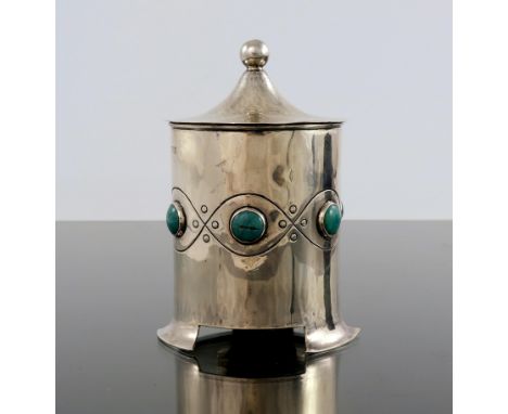 A E Jones, an Arts and Crafts silver and Ruskin cabochon tea caddy, Birmingham 1903, cylindrical form, planished, on three sp