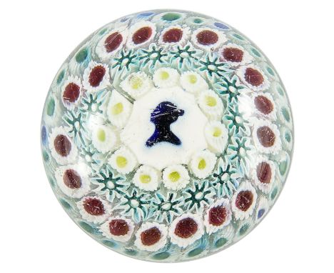 Bacchus, a silhouette concentric millefiori glass paperweight, circa 1850, the central portrait cane with the bust of a woman