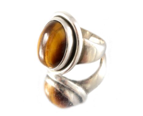 Harald Nielsen for Georg Jensen, a Danish silver and tiger's-eye ring, model 46 A, designed circa 1936, oval cabochon stone o