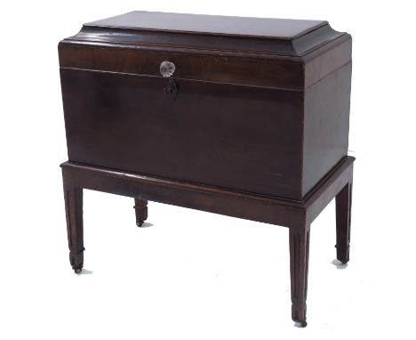 A George III mahogany cellarette, sarcophagus chest caddy from on integrated stand, the chamfered lid hinged and opening to r