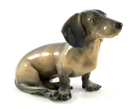 Erik Nielsen for Royal Copenhagen, a large figure of a dachshund, modelled sitting, painted marks and incised signature, 23cm