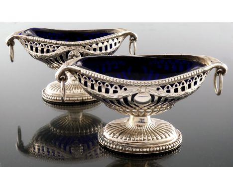A pair of Victorian silver salt cellars, Nathan and Hayes, Birmingham 1892, pedestal ogee oval boat form, reticulated with Ne