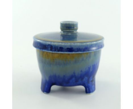 Ruskin Pottery, a Crystalline pot and cover, circa 1930, rounded form with three bracket feet, cylindrical knop to lid, bands