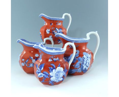 A set of four Wedgwood botanical flow blue transfer printed graduated jugs / pitchers, each jug / pitcher is brightly decorat