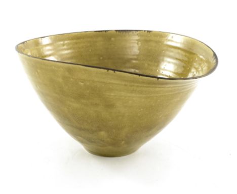 Hans Coper and Lucie Rie, a studio pottery bowl, circa 1947, rounded conical form with pouring lip, ochre glaze with manganes
