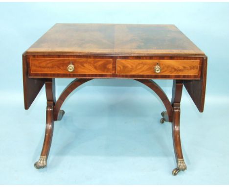 An early-19th century mahogany sofa table, the cross-banded top with two drop leaves above two drawers and two false drawers,