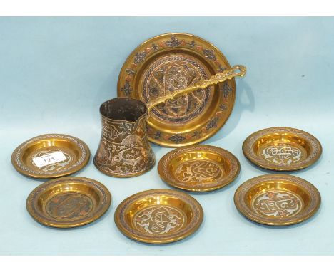 A Cairo ware coffee ladle decorated with silver and copper detail and seven small Cairo ware dishes, 9.5cm diameter.