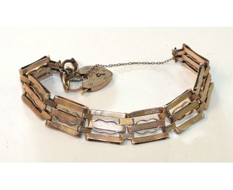 A 9ct rose gold gate-link bracelet with engine-turned links and padlock clasp, 18.6g.