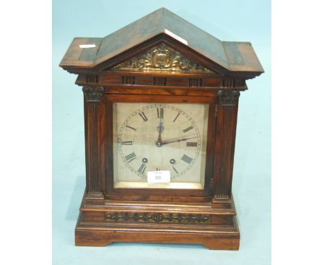 A 19th century walnut mantel clock of architectural form with 16cm silvered dial and French gong-striking movement, stamped, 