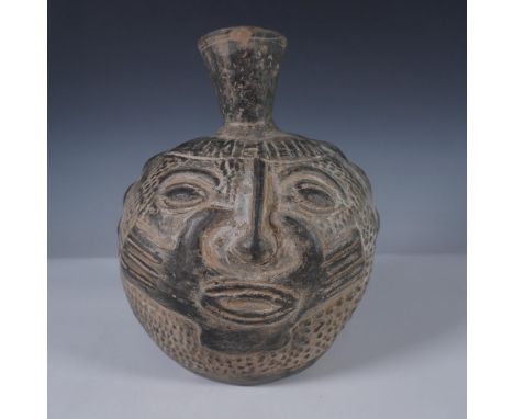 Striking hand formed pottery vessel featuring a stylized human face and raised textured detailing throughout. The facial feat