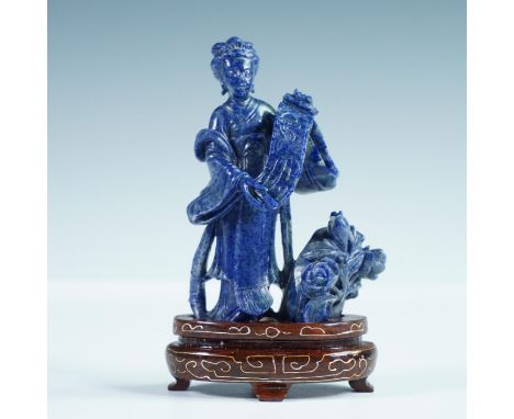Hand-carved Asian figure in lapis lazuli, depicting a graceful woman in flowing robes holding a detailed scroll beside a bloo