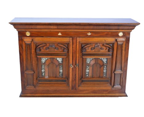 A mahogany two door cabinet with mother-of-pearl inlay, architectural panel cupboards enclosing three shelves, W135cm x D35cm