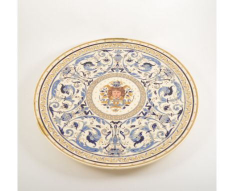 Continental pottery portrait charger, by Schutz Cilli, central painted panel, broad scrolled border, inscribed verso and date