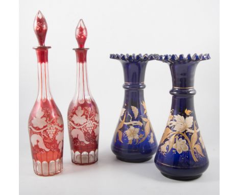 Continental pottery oil lamp; a pair of blue glass and enamelled vases, and a pair of ruby tinted cut-glass decanters.