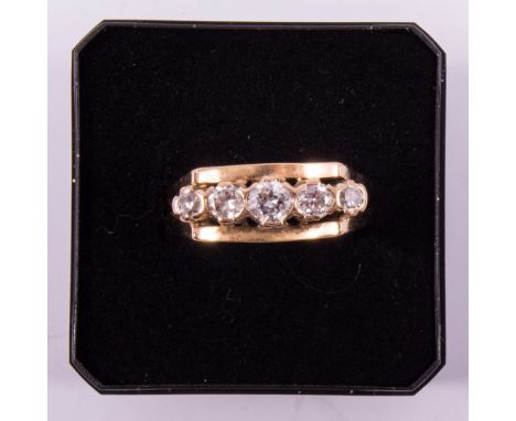 A diamond five stone ring, the brilliant and eight cut stones claw set in an all yellow metal mount with plain shank and divi