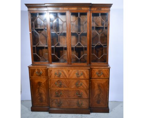 Reproduction mahogany break-front bookcase, dentil cornice, four astragal glazed panel doors to the upper section, secretaire