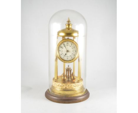 Gilt metal Anniversary clock of portico design enamelled dial, under a glass dome, 45 cm overall, (a.f.).