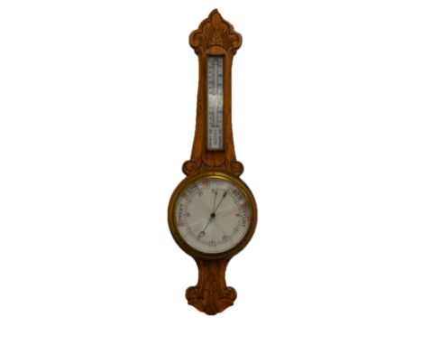 An oak cased aneroid barometer/thermometer, wall mounted, glass broken to dial. 