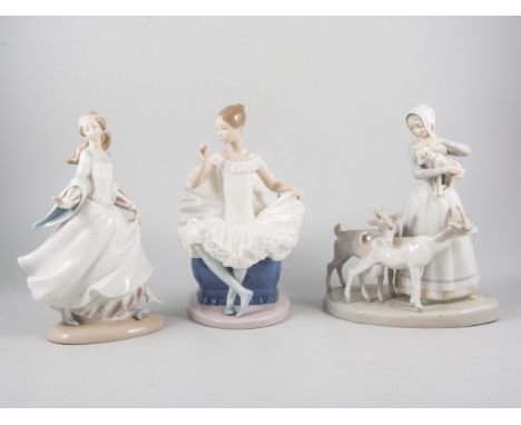 Lladro group of a girl with goats, 28cm; four other Lladro figures, and a Nao figure of a seated ballet dancer. (6)