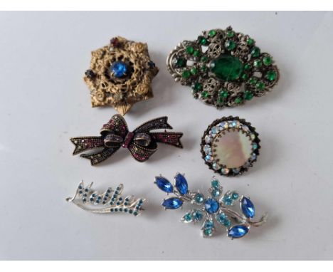 Six vintage stone set costume brooches
