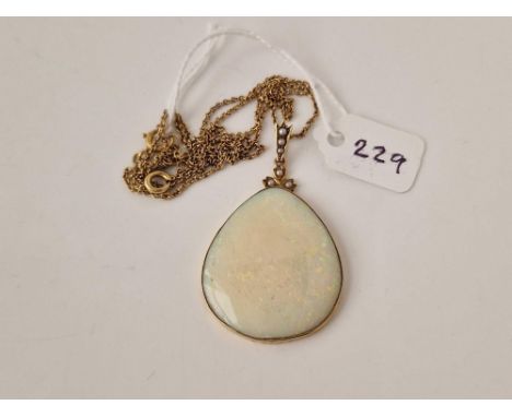 A LARGE PEAR SHAPED OPAL PENDANT SET IN 15CT GOLD WITH HALF PEARL HIGHLIGHTS ON 9CT CHAIN