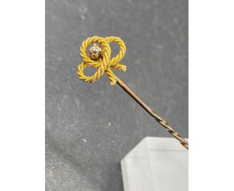 A Vintage rope twist stick pin with diamond feature set in gold