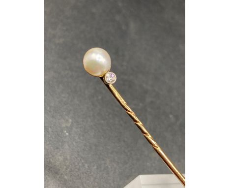 A vintage real pearl and diamond stick pin