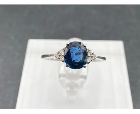 A pretty sapphire ring with diamond shoulders 18ct gold tested size O 2.6 gms