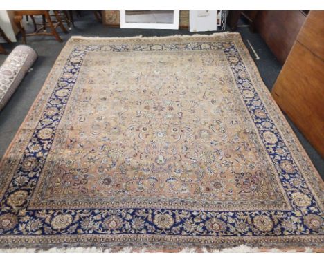 A good Oriental carpet with blue border and pink ground centre, 13ft x 10ft approx